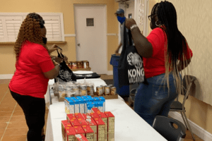 Two women assembling gift bags